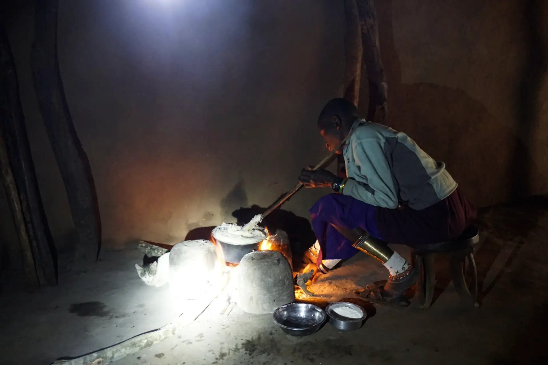 Masai woman cooking ugali, Tanzania - Experiencing The Globe