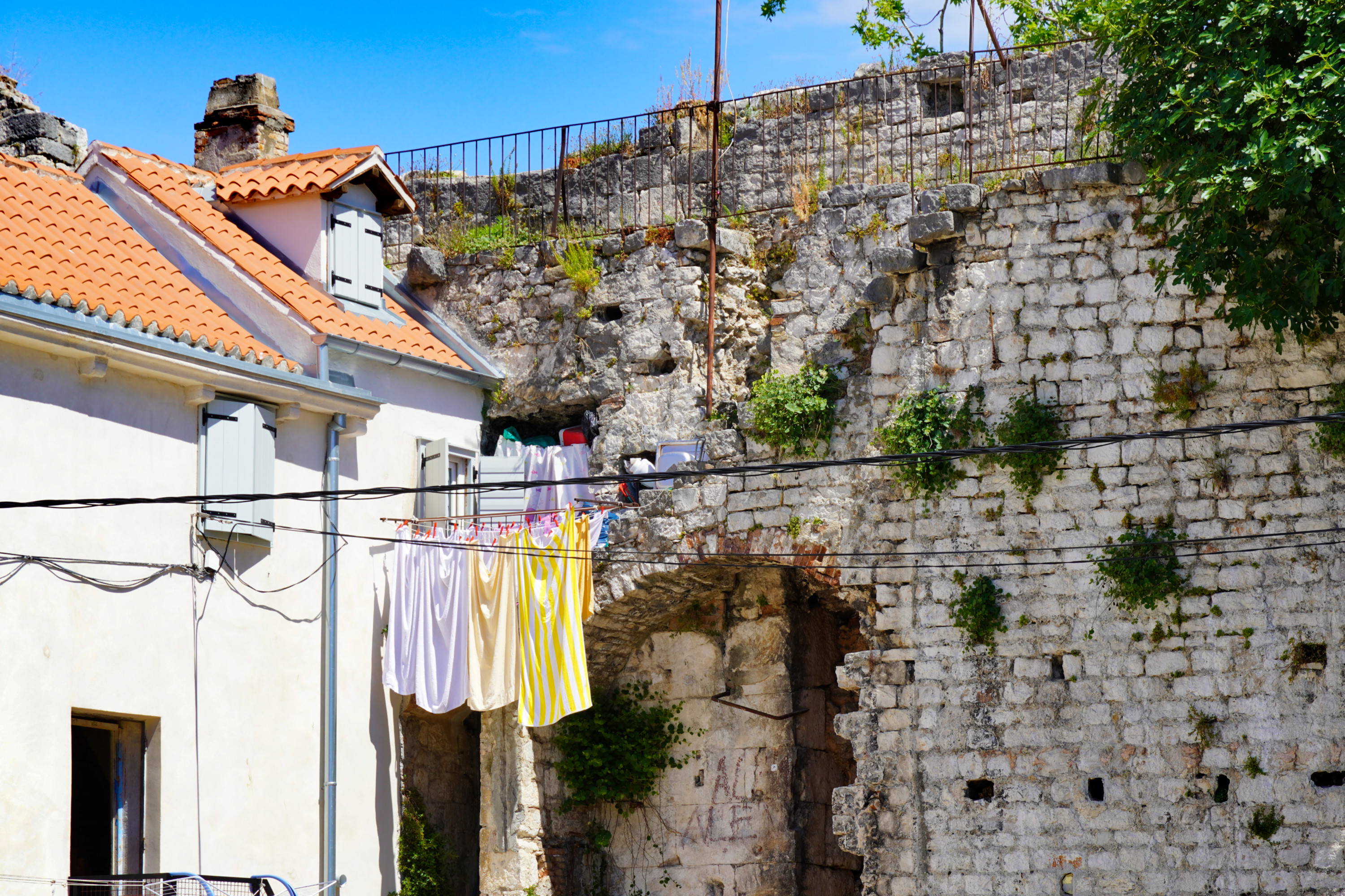 People still live inside the palace, and even use the original walls as an extention of their homes, Split, Croatia - Experiencing the Globe