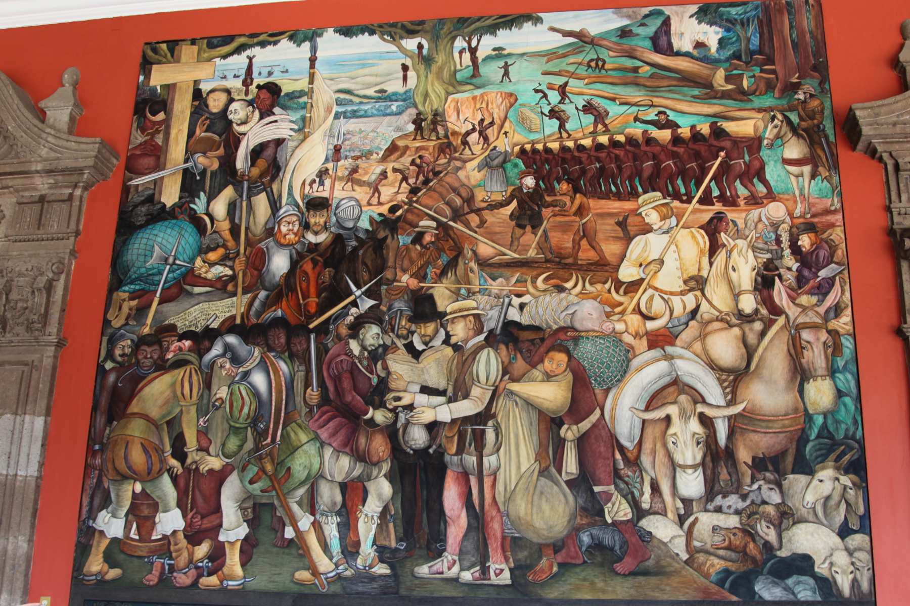 The Arrival of Cortés, a mural by Diego Rivera highlighting the brutality of colonialism, located in the National Palace of Mexico City - Experiencing the Globe